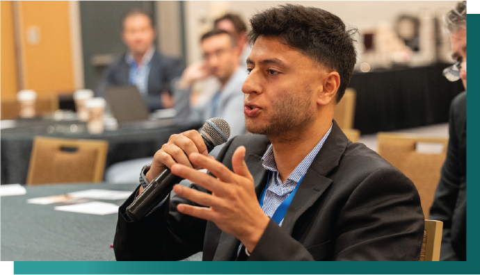 Audience engagement during AI technology forum, Participant contributing to oil and gas innovation panel, Live Q&A session at industrial digitalization conference