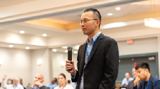 Industry expert sharing insights during digital transformation session at AI in Oil and Gas Houston, Participant presenting viewpoint at oil and gas technology conference, Energy professional contributing to live discussion at AIOG networking session